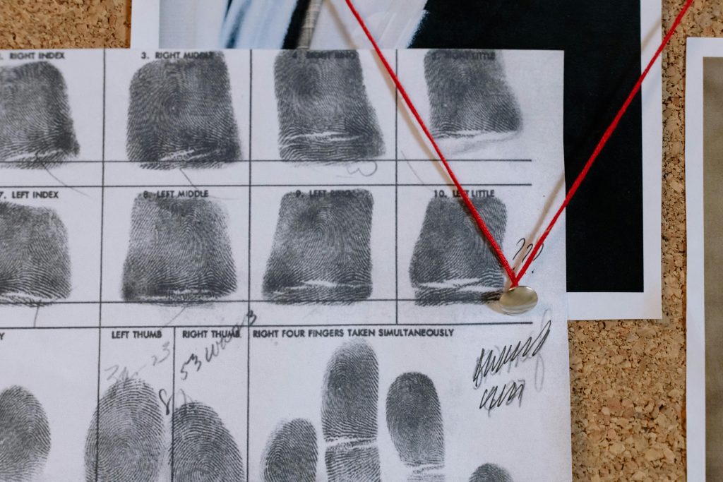 Fingerprint Evidence Isn’t What You Think: The Truth About Guilt in Court Detailed close-up of fingerprint card pinned on a corkboard, showcasing identity documentation.